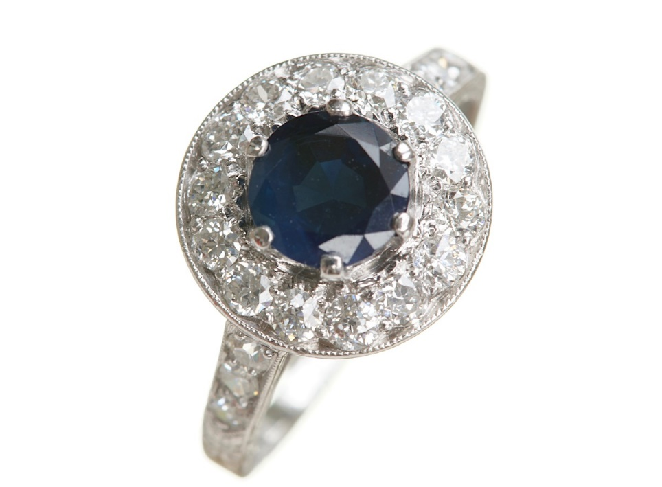 A blue gemstone placed in the middle of diamonds