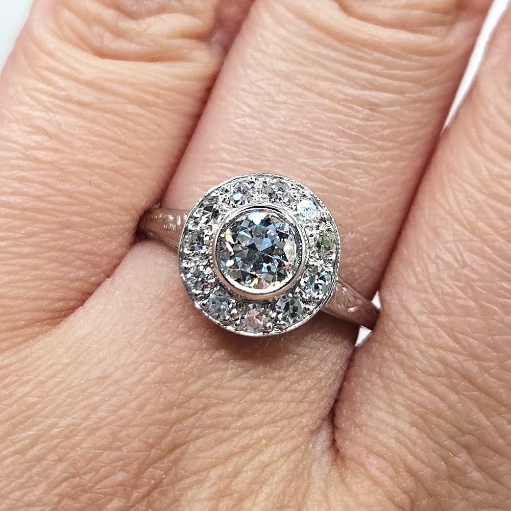 Vintage-style platinum diamond ring with 0.70ct and 0.55ct stones on hand